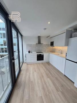 Battersea kitchen renovation with white cabinetry, wood flooring and balcony doors