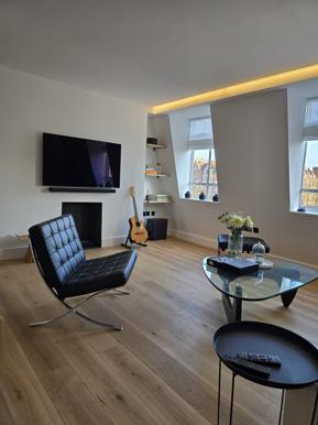 Marylebone living room after a full flat renovation, refinished with wood flooring and modern fittings