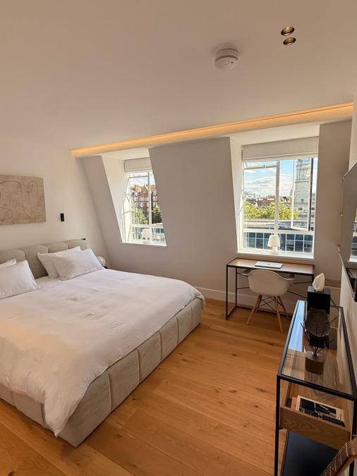 Second bedroom view in the Marylebone flat showing a desk nook beneath dormer windows