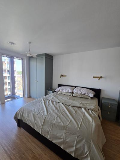 Dalston bedroom after renovation with fitted wardrobe and balcony doors