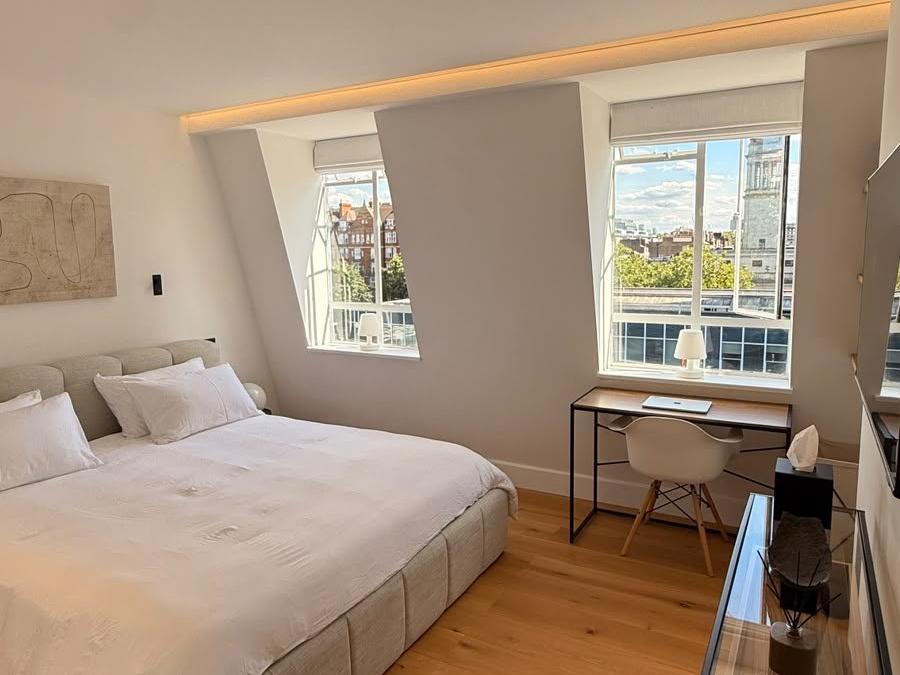 Second bedroom view in the Marylebone flat showing a desk nook beneath dormer windows
