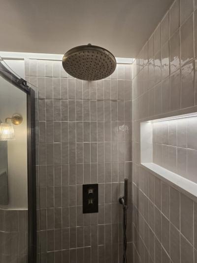 Rotherhithe bathroom rainfall showerhead and tiled niche detail