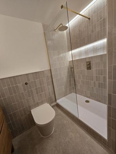 Rotherhithe second bathroom wide view with toilet, walk-in shower and gold fittings