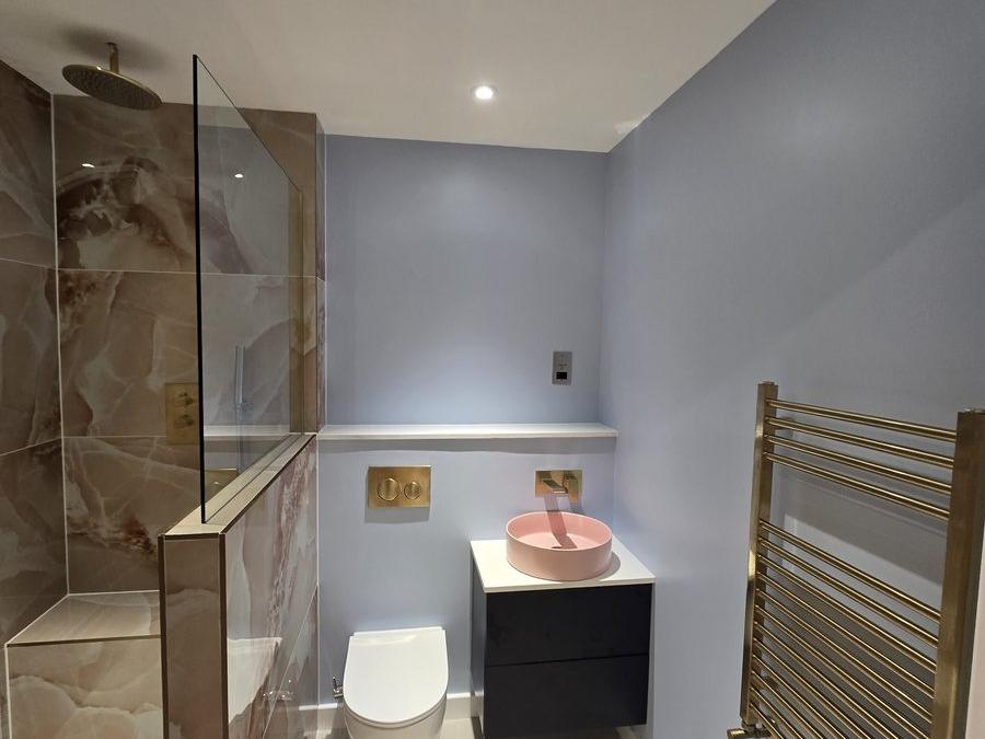 Shower room in the Stratford flat with a new enclosure, countertop basin and wall-hung vanity