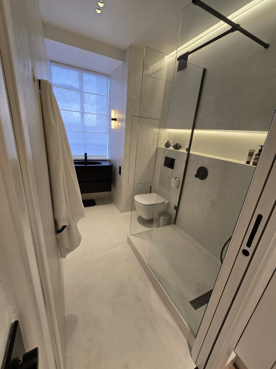 Marylebone bathroom with glass shower screen and concrete-effect walls