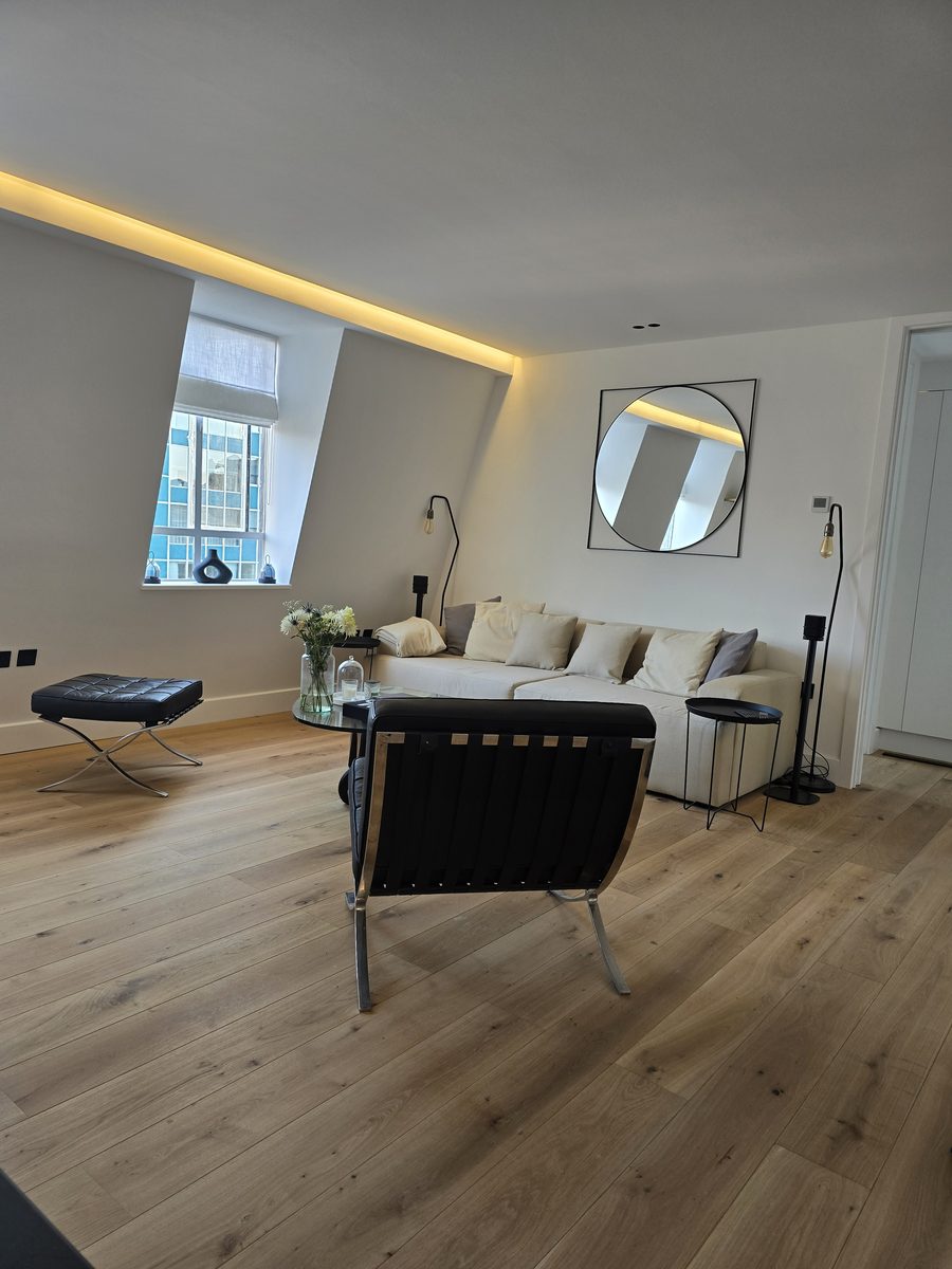 Marylebone living room styled with wood flooring and warm lighting