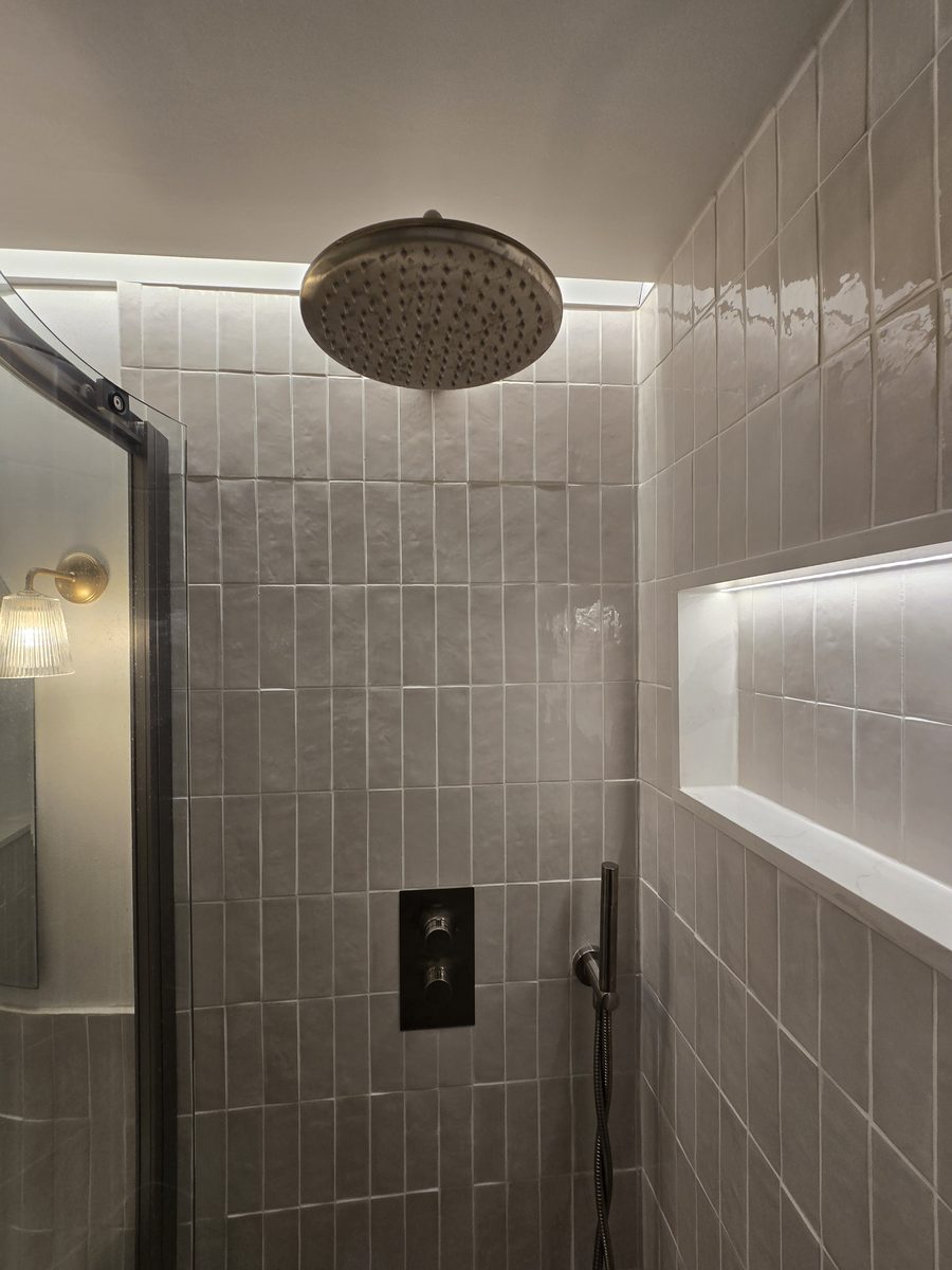 Rotherhithe bathroom rainfall showerhead and tiled niche detail